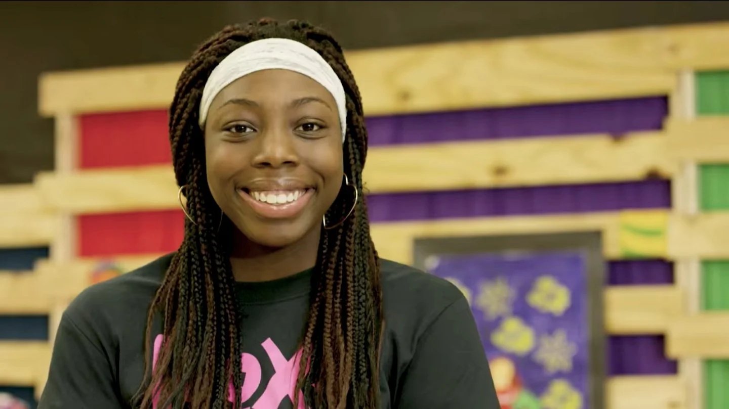 A ROX girl smiling confidently into the camera