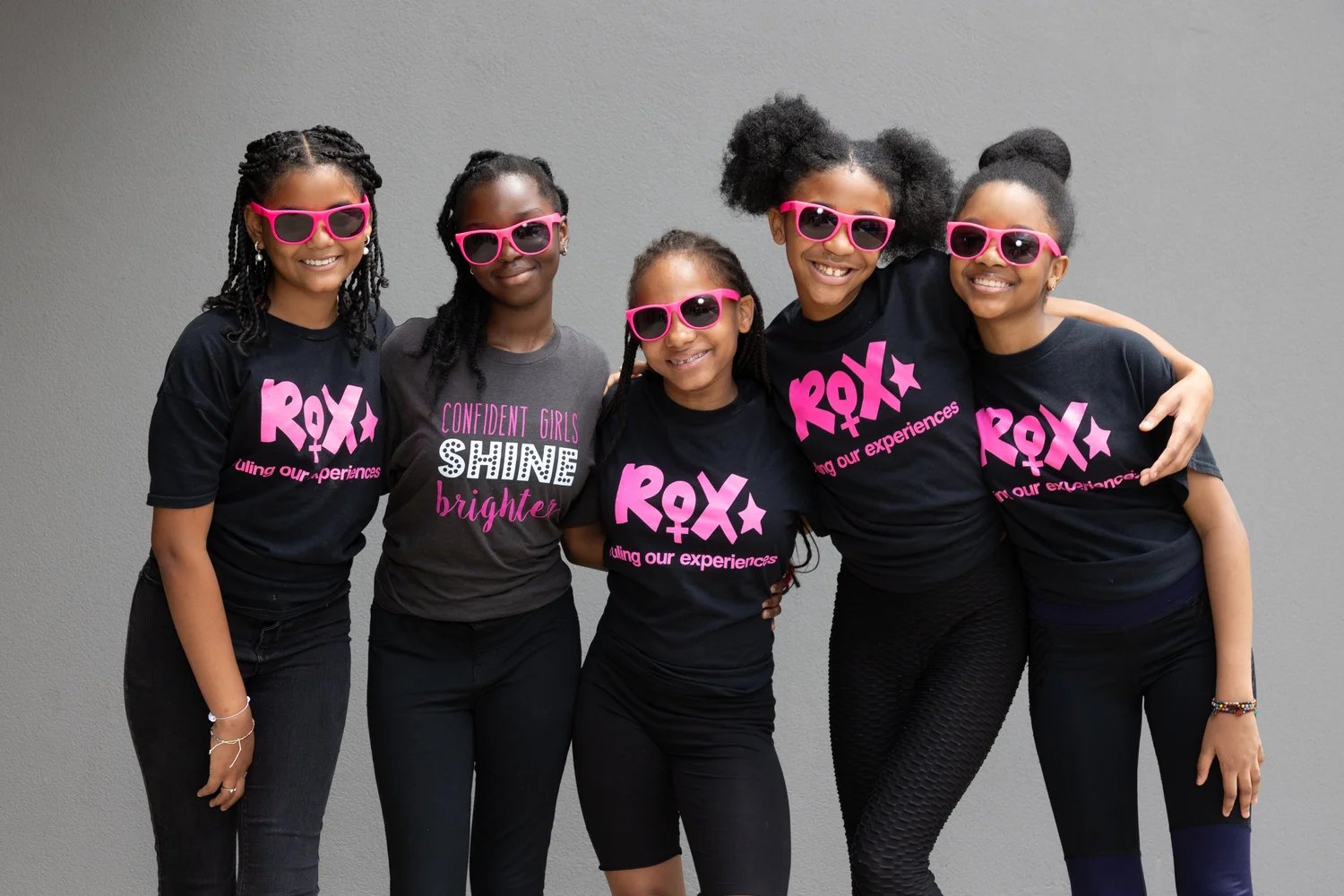 ROX girls arm-in-arm, smiling and confident